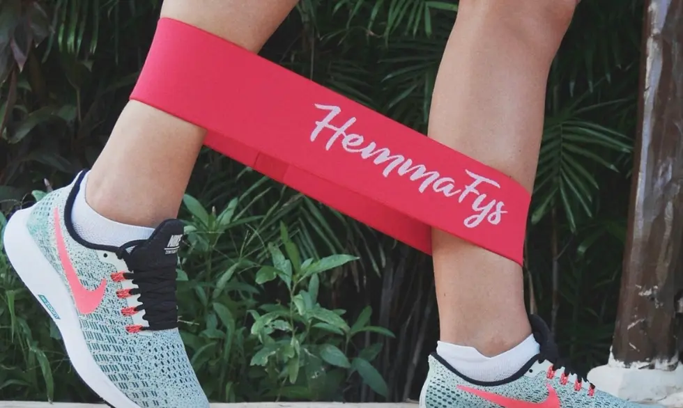 Untitled design - 2025-09-10T101154.087 Close-up of a woman’s legs actively stretching with resistance bands, demonstrating Active Stretching with Resistance Bands for outdoor fitness.